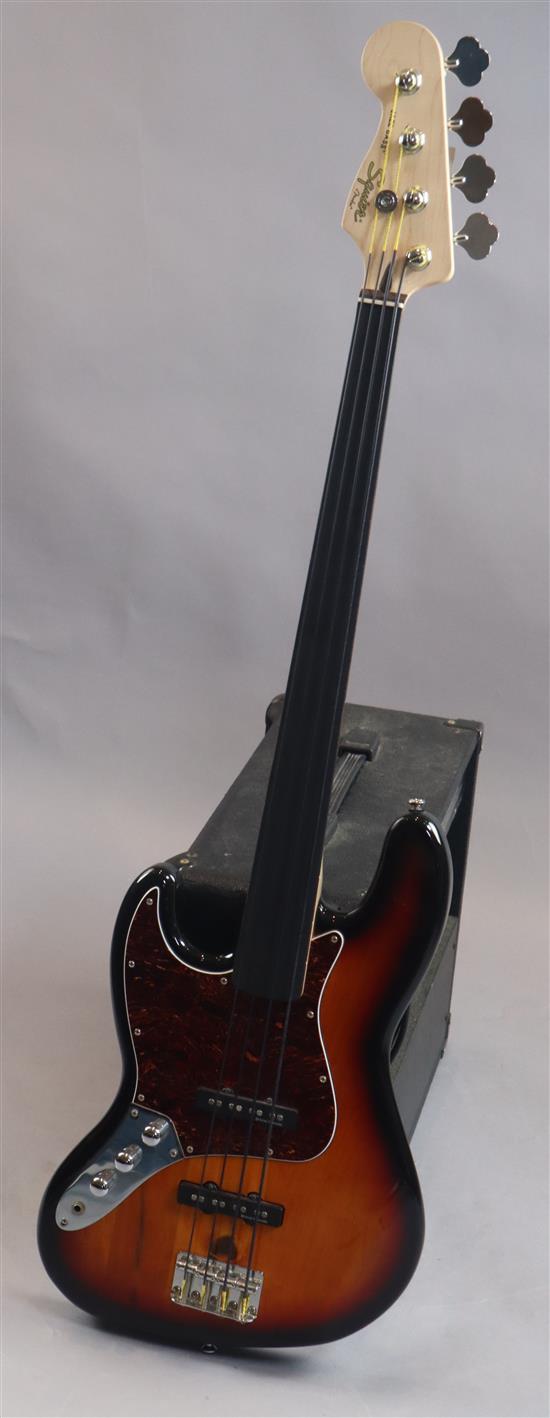 A Squire jazz bass, left handed fretless bass guitar